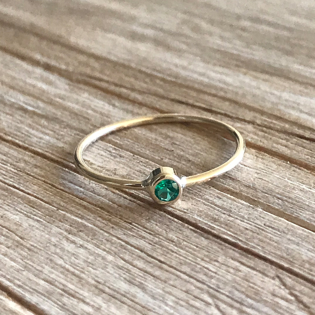 Emerald Bezel Ring on Wood